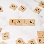 the word talk is spelled out in scrabble letters